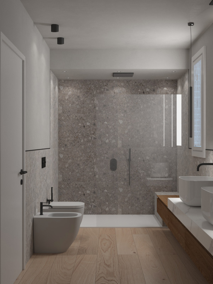 This is an example of a large contemporary 3/4 bathroom in Venice with flat-panel cabinets, light wood cabinets, an open shower, a two-piece toilet, gray tile, porcelain tile, grey walls, wood-look tile, a vessel sink, beige floor, an open shower, a shower seat, a double vanity, a floating vanity and recessed.