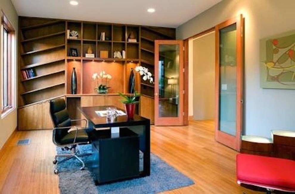Mid-sized contemporary home office in Orange County with a freestanding desk, light hardwood floors and no fireplace.