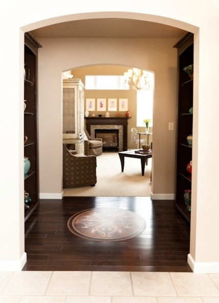 Foyer - small transitional dark wood floor foyer idea in Charlotte with beige walls