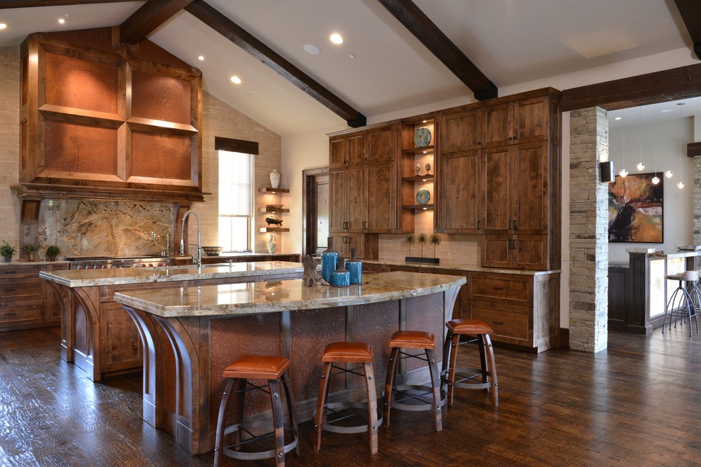 This is an example of a large transitional u-shaped open plan kitchen in Dallas with recessed-panel cabinets, medium wood cabinets, brown splashback, stone slab splashback, an undermount sink, granite benchtops, panelled appliances, dark hardwood floors and multiple islands.