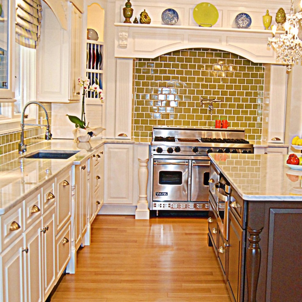This is an example of a large traditional u-shaped eat-in kitchen in Atlanta with raised-panel cabinets, white cabinets, quartzite benchtops, green splashback, subway tile splashback, stainless steel appliances, bamboo floors, with island and a double-bowl sink.