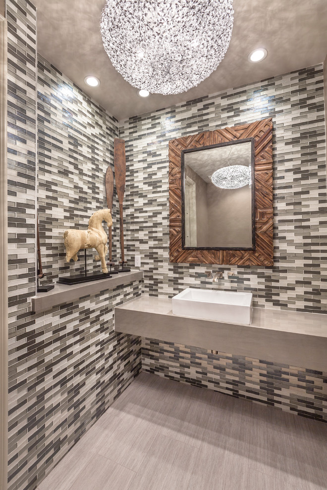Inspiration for a small contemporary powder room in Las Vegas with gray tile, matchstick tile, ceramic floors, a vessel sink and solid surface benchtops.