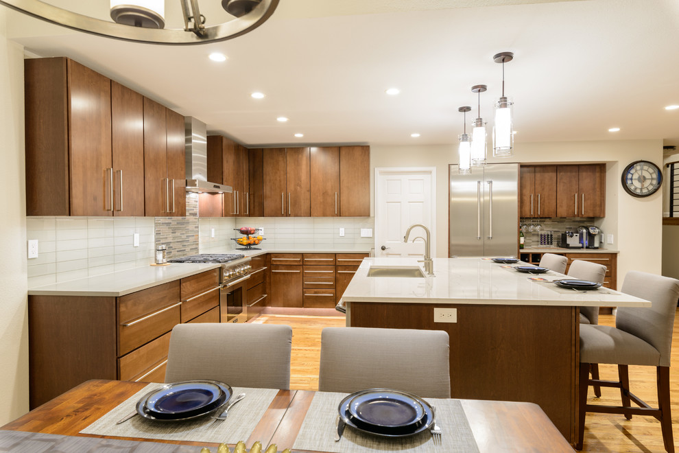 Inspiration for a mid-sized contemporary l-shaped light wood floor and brown floor open concept kitchen remodel in Denver with an undermount sink, flat-panel cabinets, dark wood cabinets, marble countertops, multicolored backsplash, matchstick tile backsplash, stainless steel appliances and an island