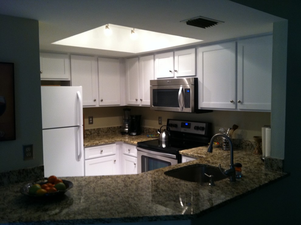Inspiration for a small transitional u-shaped travertine floor open concept kitchen remodel with a drop-in sink, shaker cabinets, white cabinets, granite countertops, multicolored backsplash, stone slab backsplash, stainless steel appliances and no island