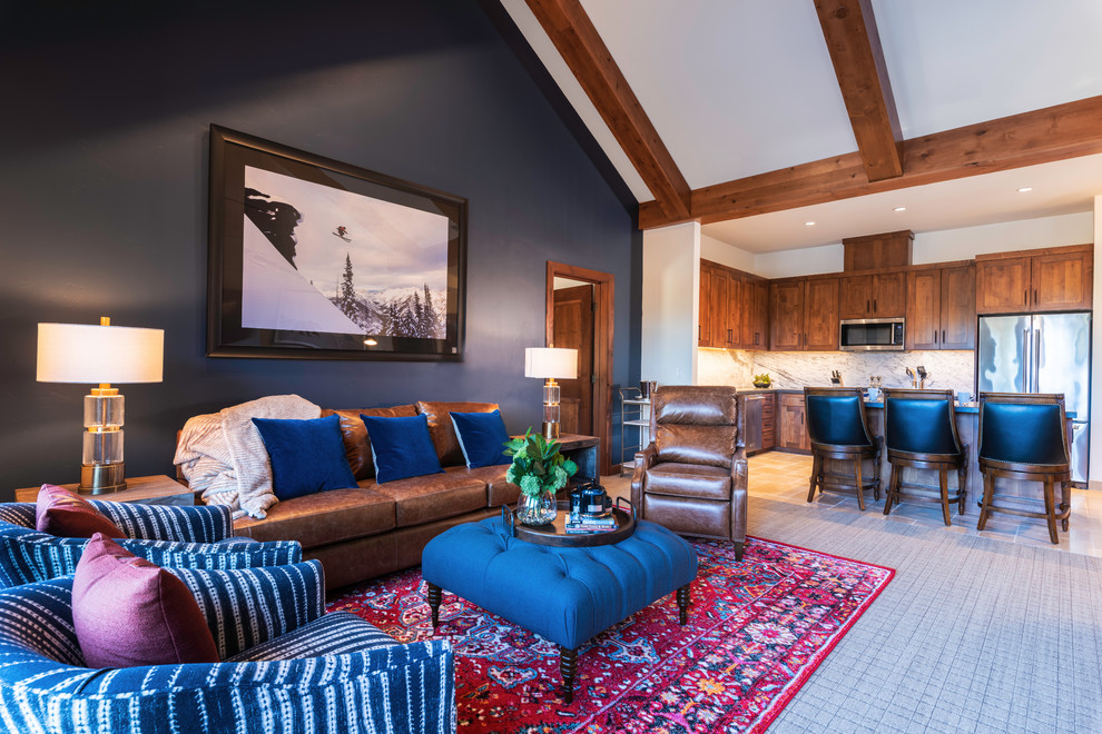 Inspiration for a mid-sized country open concept family room in Other with blue walls, carpet, a standard fireplace, a stone fireplace surround, a wall-mounted tv and multi-coloured floor.
