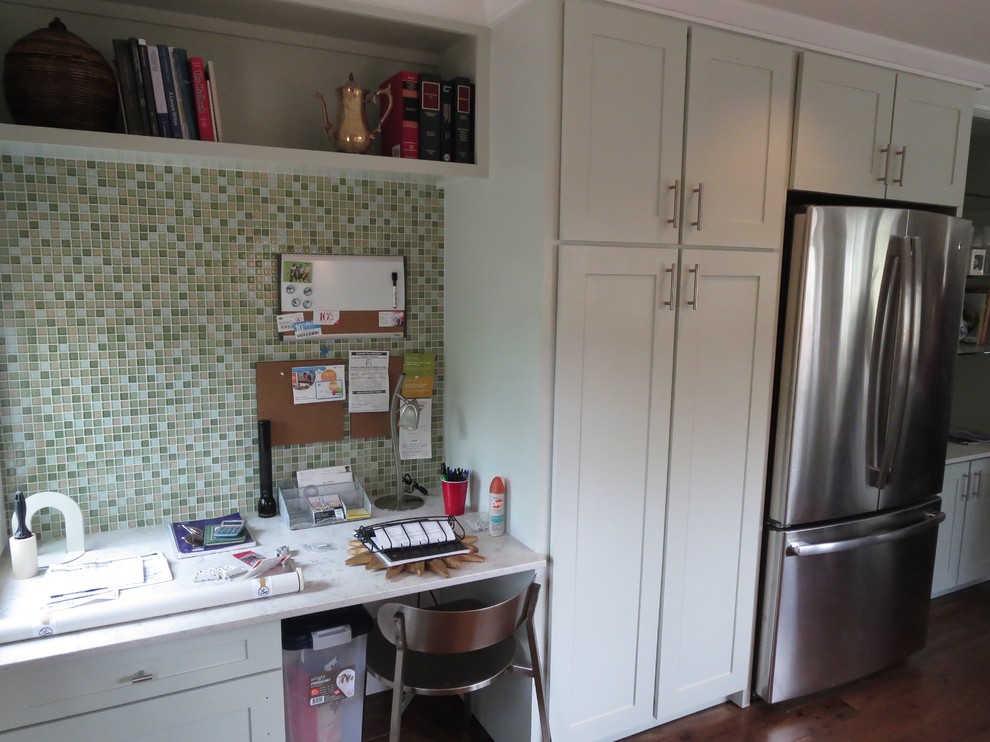 Example of a mid-sized transitional medium tone wood floor eat-in kitchen design in Austin with shaker cabinets, glass tile backsplash, stainless steel appliances, a single-bowl sink, green cabinets, quartz countertops, green backsplash and a peninsula