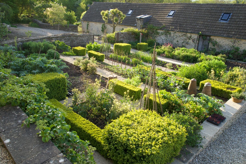 This is an example of a small country courtyard garden in Gloucestershire with a vegetable garden.