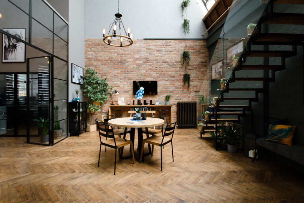This is an example of a mid-sized industrial craft room in London with wood walls.