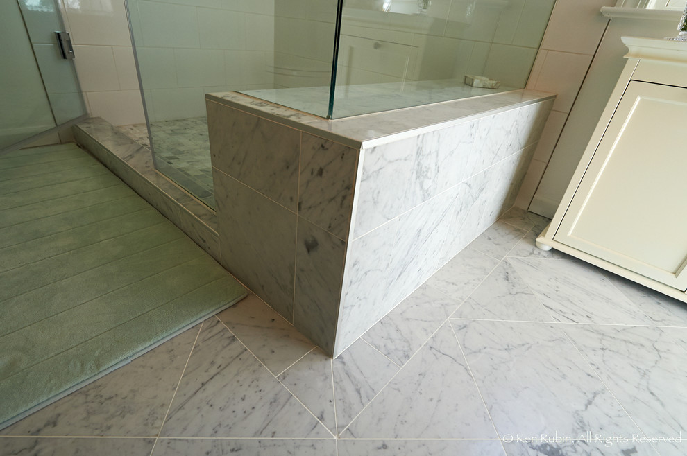 Corner shower - large transitional master gray tile, white tile and stone tile marble floor corner shower idea in DC Metro with recessed-panel cabinets, white cabinets, a two-piece toilet, white walls, an undermount sink and granite countertops