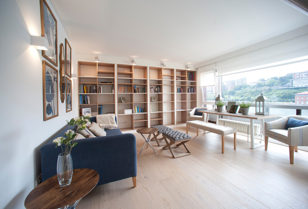 This is an example of a large beach style open concept living room in Bilbao with a library.