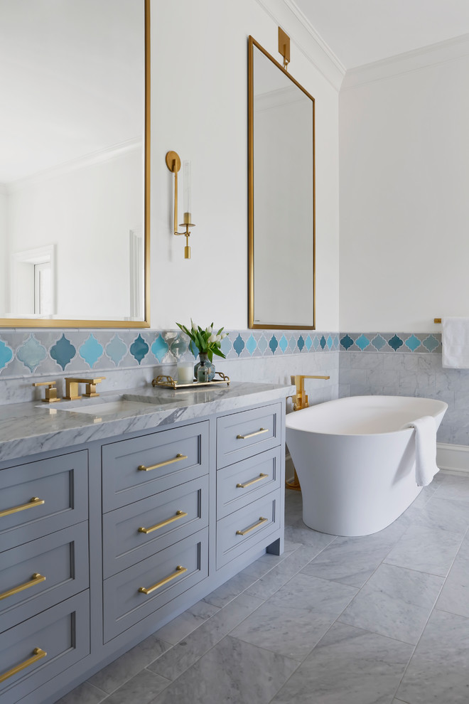 Design ideas for a large transitional master bathroom in Nashville with a freestanding tub, blue tile, marble, white walls, marble floors, an undermount sink, marble benchtops, recessed-panel cabinets, grey cabinets, grey floor and grey benchtops.