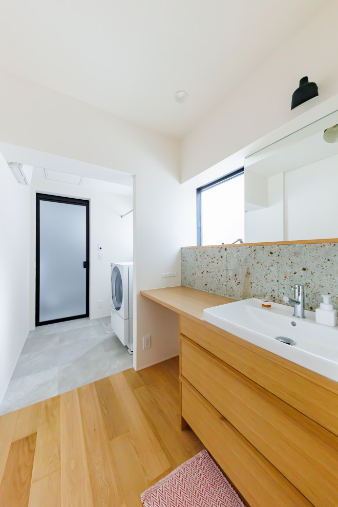 This is an example of a medium sized scandi cloakroom in Other with medium wood cabinets, stone tiles, white walls, medium hardwood flooring, wooden worktops, brown floors, brown worktops, a wallpapered ceiling and wallpapered walls.