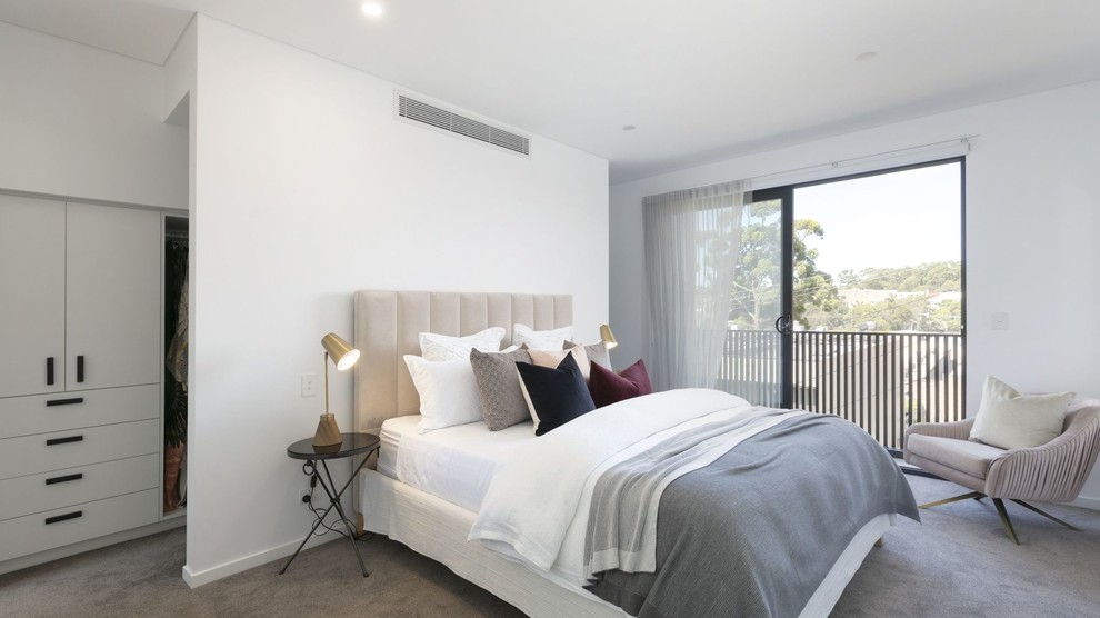 Contemporary bedroom in Sydney with white walls, carpet and grey floor.