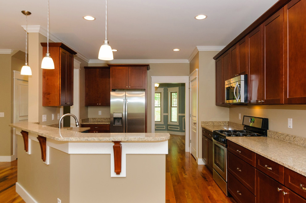 Transitional light wood floor eat-in kitchen photo with a double-bowl sink, recessed-panel cabinets, medium tone wood cabinets, granite countertops and an island