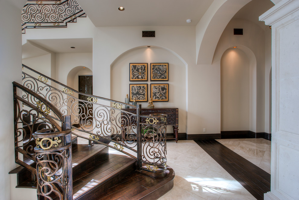 Design ideas for an expansive mediterranean foyer in Phoenix with white walls, porcelain floors, a double front door, a glass front door and white floor.