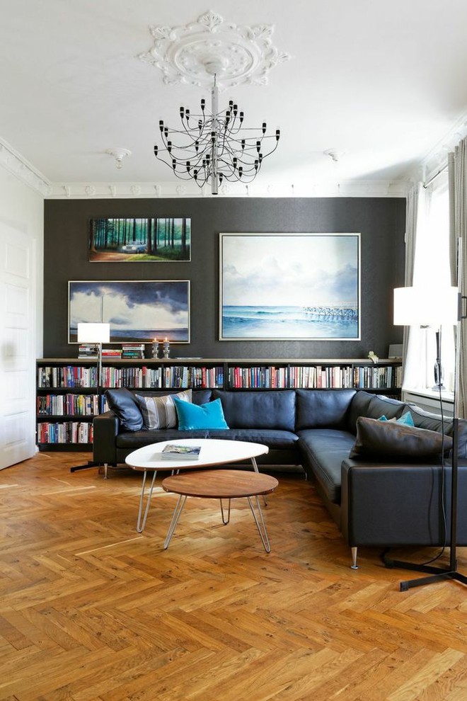 Design ideas for a scandinavian living room in Copenhagen with black walls, medium hardwood floors and brown floor.