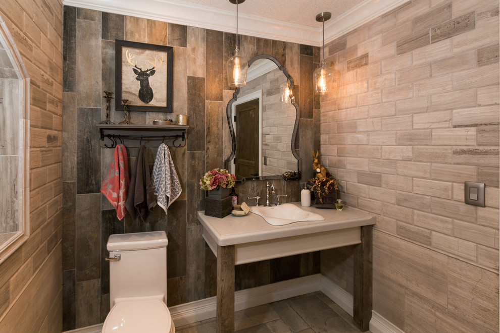 Design ideas for a large country powder room in Orange County with a one-piece toilet, brown tile, a drop-in sink, porcelain tile, grey walls, grey floor and grey benchtops.