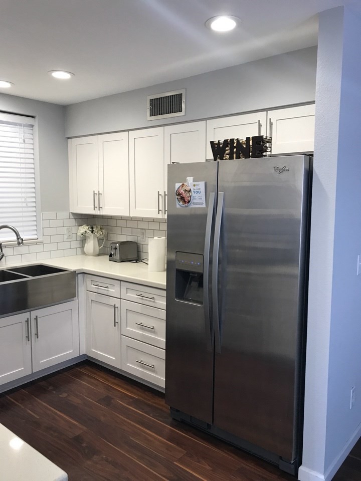 This is an example of a small traditional galley eat-in kitchen in Phoenix with a farmhouse sink, shaker cabinets, white cabinets, quartzite benchtops, white splashback, subway tile splashback, stainless steel appliances and no island.