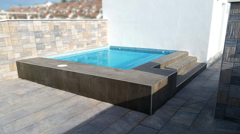 Design ideas for a mid-sized contemporary rooftop rectangular aboveground pool in Other with a pool house.