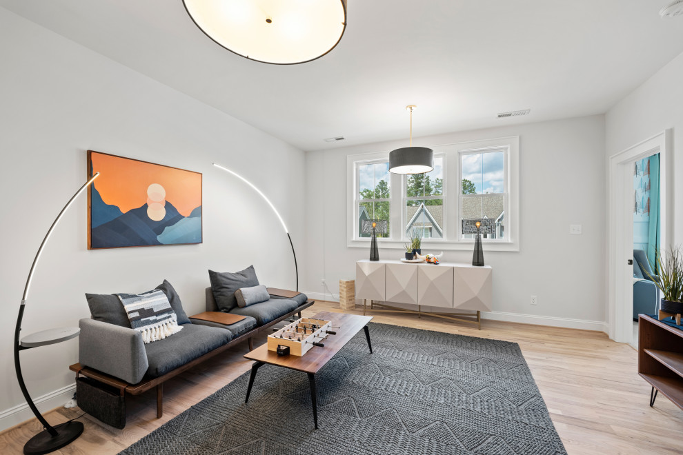 The Cardinal - Inspiration for a mid-sized contemporary loft-style light wood floor and beige floor game room remodel in Richmond with white walls, no fireplace and no tv