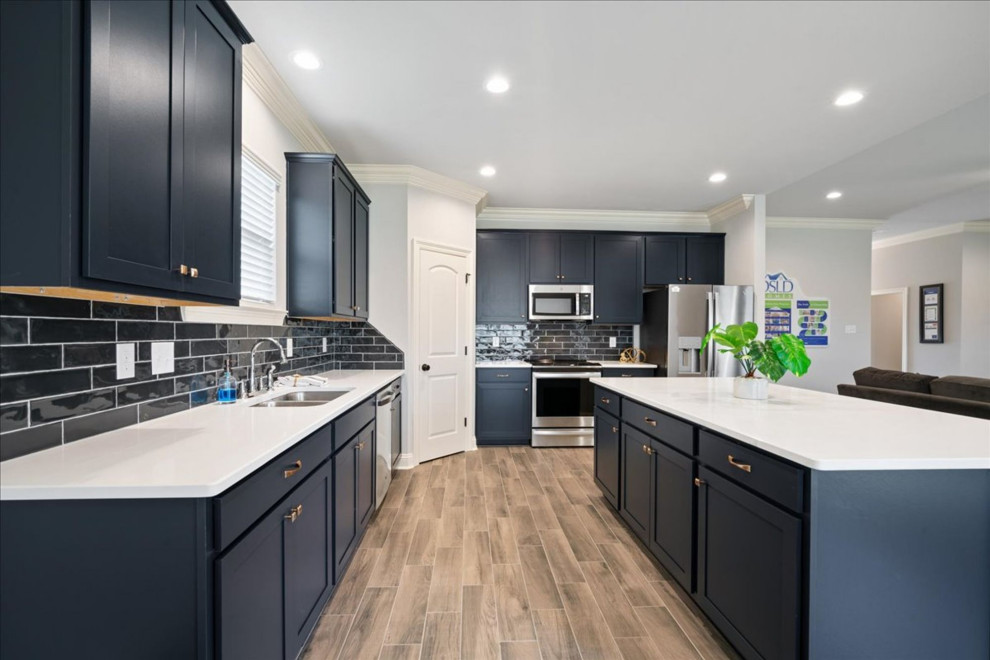 Example of a mid-sized transitional ceramic tile and beige floor eat-in kitchen design with a double-bowl sink, blue cabinets, granite countertops, blue backsplash, ceramic backsplash, stainless steel appliances, an island and white countertops