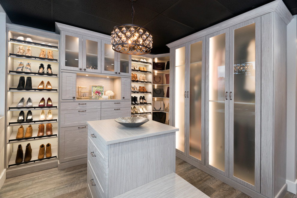 Inspiration for a large contemporary women's walk-in wardrobe in Other with shaker cabinets, white cabinets, porcelain floors and brown floor.
