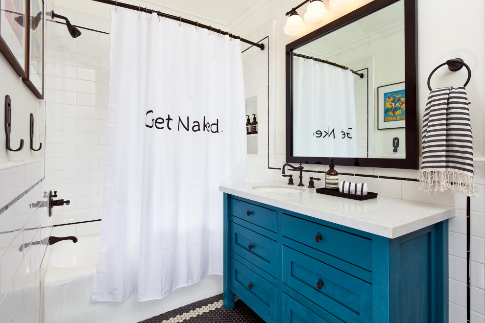 This is an example of a mid-sized traditional kids bathroom in San Francisco with shaker cabinets, blue cabinets, an alcove tub, a shower/bathtub combo, ceramic tile, white walls, ceramic floors, an undermount sink, black floor, a shower curtain, white benchtops, a single vanity and a freestanding vanity.