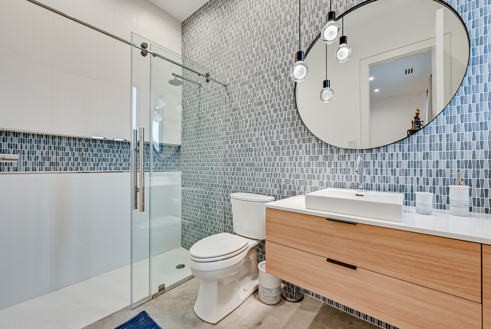 Inspiration for a contemporary bathroom in Dallas with flat-panel cabinets, light wood cabinets, an alcove shower, a two-piece toilet, a vessel sink, grey floor, a sliding shower screen, white benchtops, a single vanity and a floating vanity.