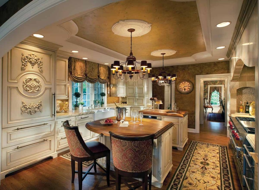 Example of a huge classic u-shaped open concept kitchen design in Orange County with beaded inset cabinets, white cabinets, wood countertops, multicolored backsplash, mosaic tile backsplash and two islands