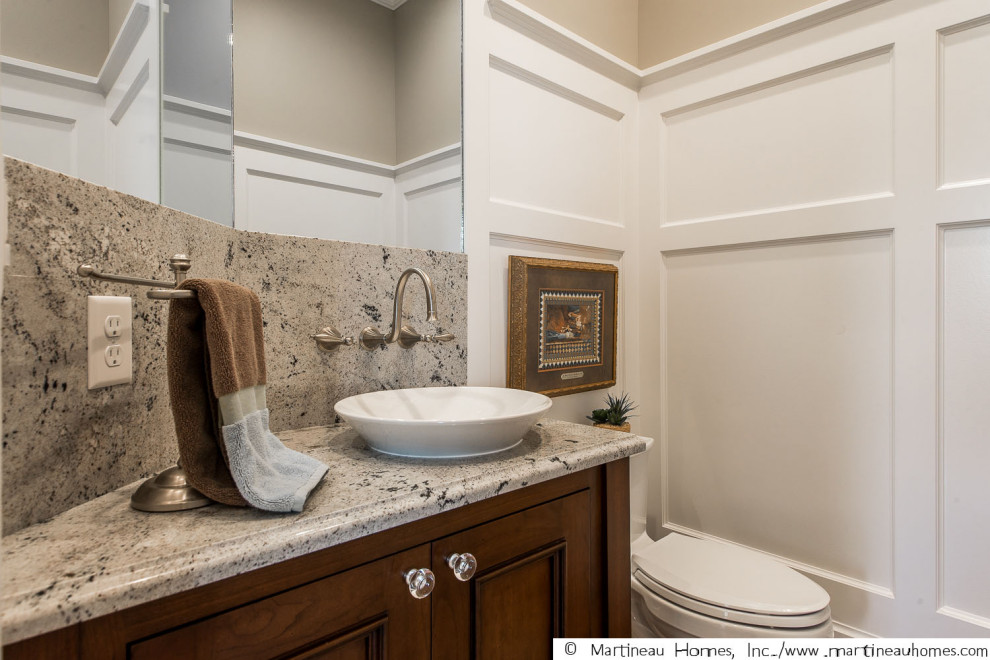 Design ideas for a mid-sized traditional 3/4 bathroom in Salt Lake City with medium wood cabinets, an open shower, a one-piece toilet, beige walls, a vessel sink, granite benchtops, grey floor, an open shower, multi-coloured benchtops, a single vanity, a built-in vanity and decorative wall panelling.