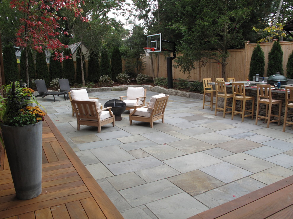 Mid-sized traditional backyard patio in Providence with an outdoor kitchen and natural stone pavers.