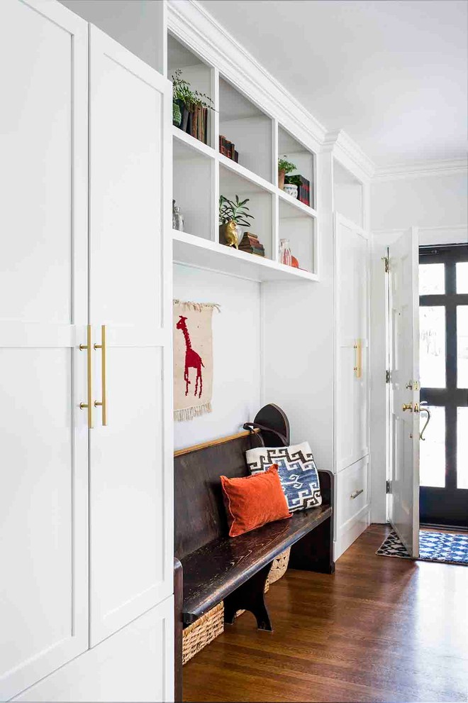 Large transitional medium tone wood floor mudroom photo in Atlanta with white walls