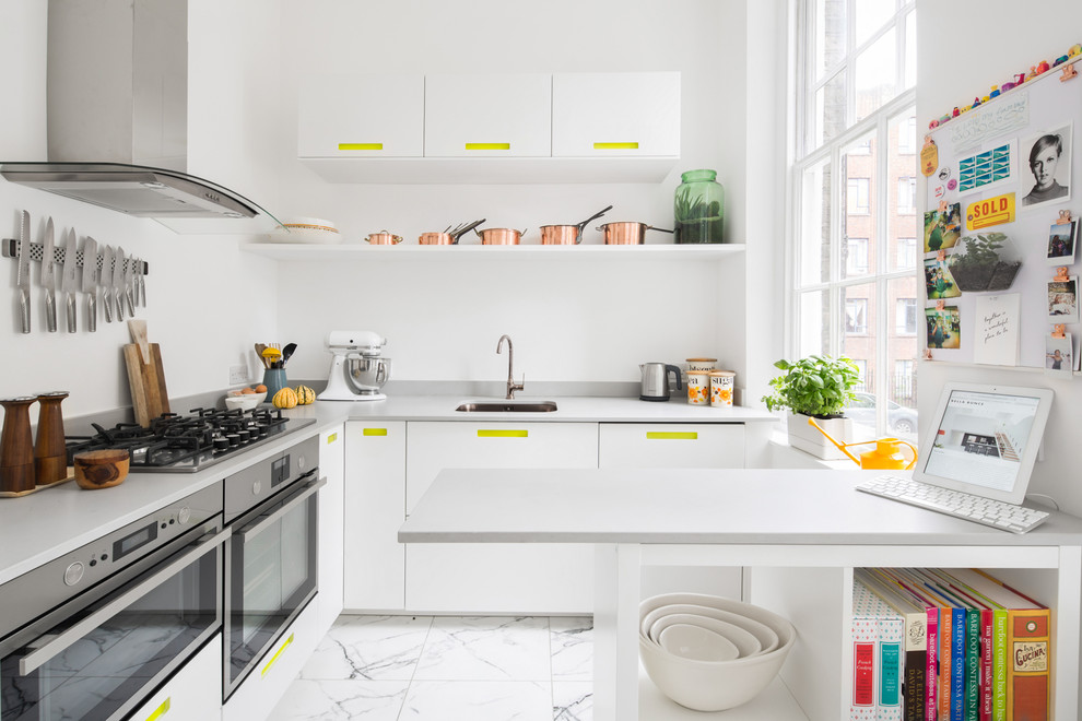 Photo of a small contemporary u-shaped separate kitchen in London with flat-panel cabinets, white cabinets, stainless steel appliances, white floor, ceramic floors, an undermount sink and a peninsula.
