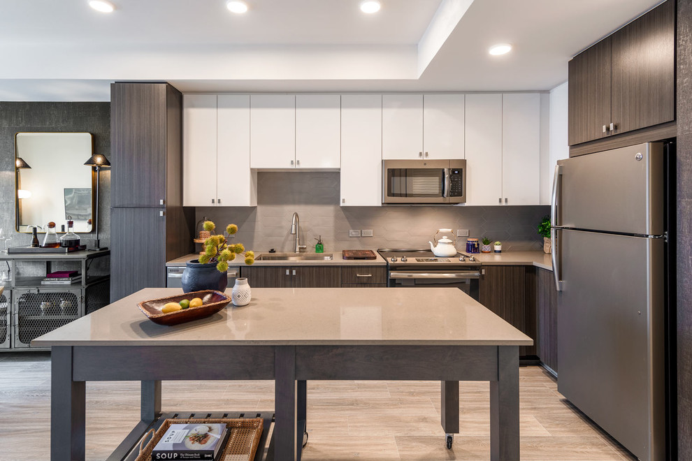Design ideas for a contemporary l-shaped kitchen in DC Metro with an undermount sink, flat-panel cabinets, brown cabinets, beige splashback, with island, beige floor and beige benchtop.