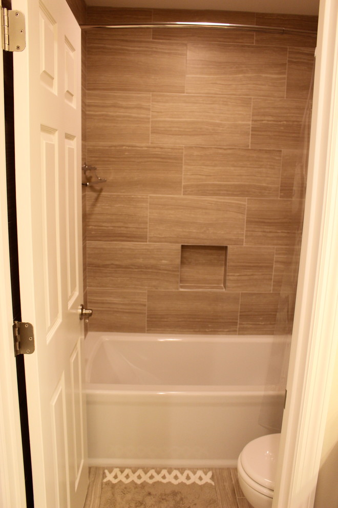 Inspiration for a small transitional kids' gray tile and porcelain tile porcelain tile alcove bathtub remodel in Cincinnati with furniture-like cabinets, dark wood cabinets, a two-piece toilet, gray walls, an undermount sink and granite countertops