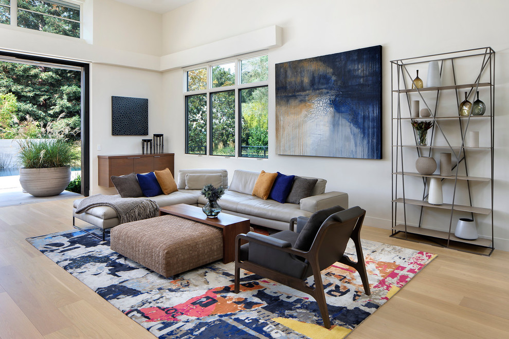 Design ideas for a contemporary open concept family room in San Francisco with white walls and light hardwood floors.