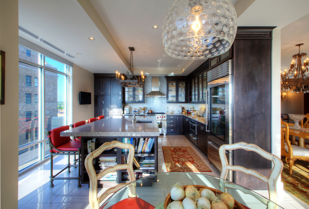 Inspiration for a mid-sized transitional l-shaped porcelain tile enclosed kitchen remodel in Indianapolis with an undermount sink, shaker cabinets, dark wood cabinets, quartz countertops, white backsplash, glass tile backsplash, stainless steel appliances and an island