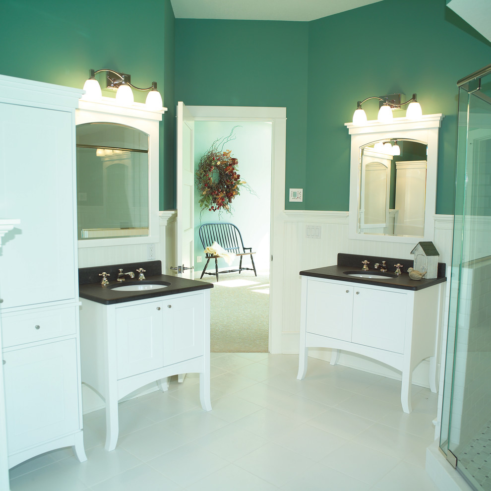 Mid-sized arts and crafts master bathroom in Cedar Rapids with an undermount sink, recessed-panel cabinets, white cabinets, granite benchtops, white tile, ceramic tile, green walls and ceramic floors.