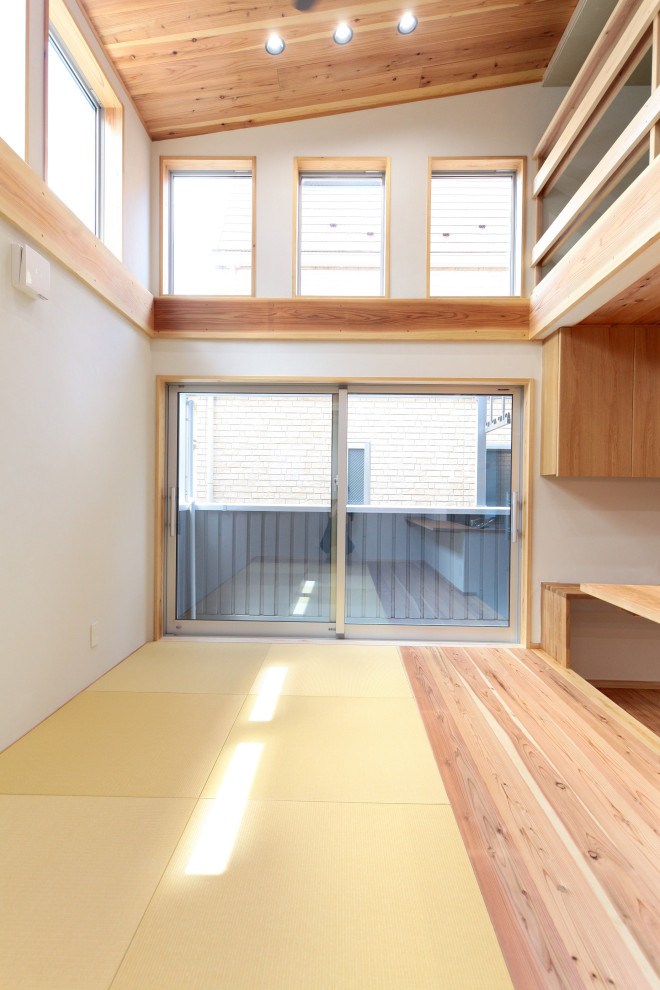 Inspiration for a mid-sized transitional formal open concept living room in Tokyo with white walls, tatami floors, no fireplace, a freestanding tv and beige floor.