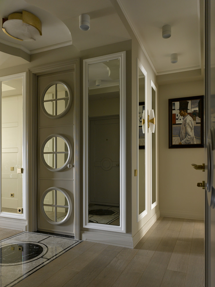 Photo of a large transitional hallway in Moscow with marble floors, beige floor and beige walls.