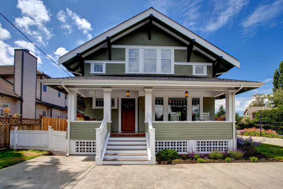 Design ideas for an arts and crafts two-storey green exterior in Seattle.