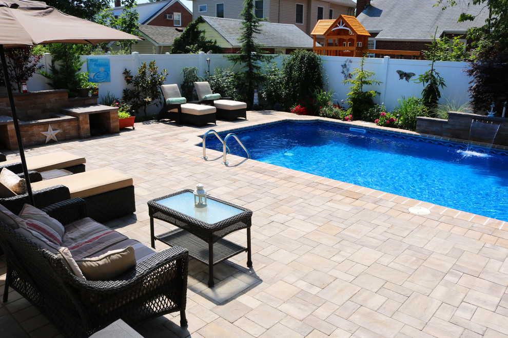 Photo of a traditional backyard patio in New York with a water feature.