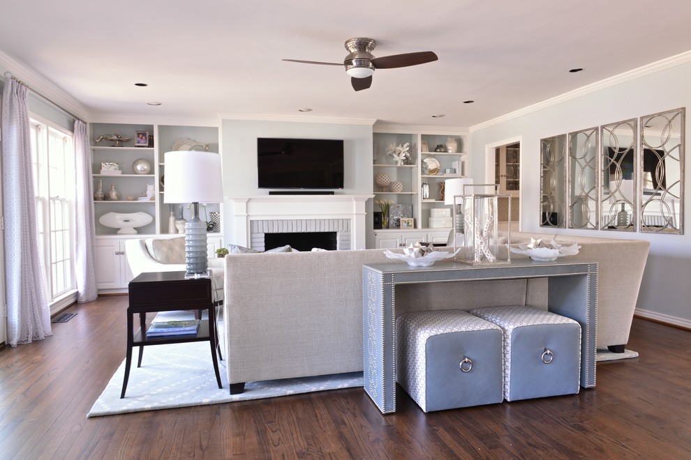 Large transitional open concept family room in Dallas with dark hardwood floors, a standard fireplace, a brick fireplace surround, a wall-mounted tv and grey walls.