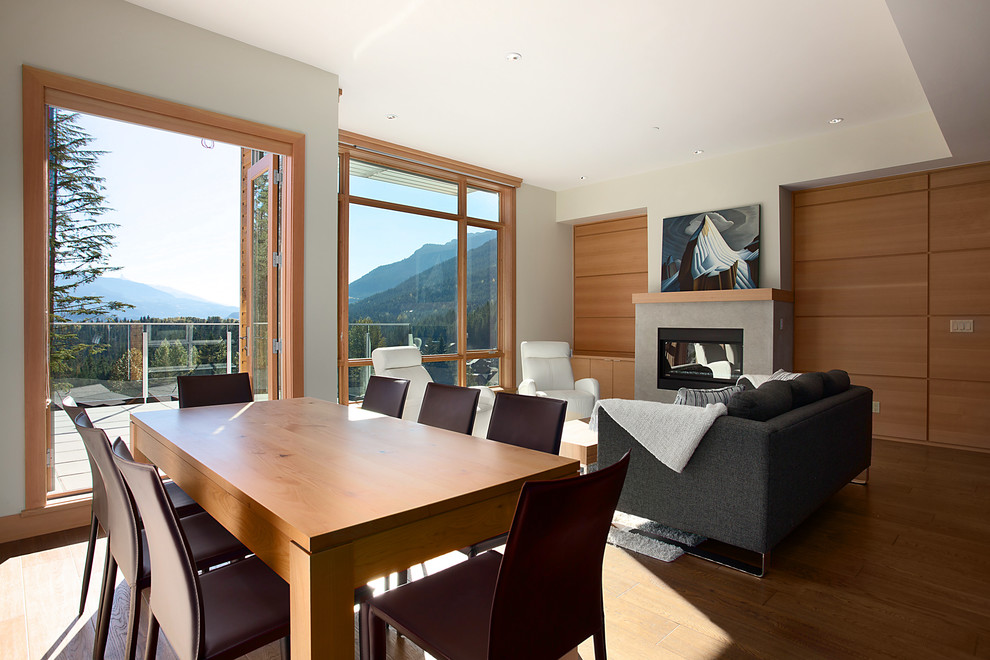 This is an example of a contemporary formal open concept living room in Vancouver with beige walls, medium hardwood floors, a ribbon fireplace and no tv.