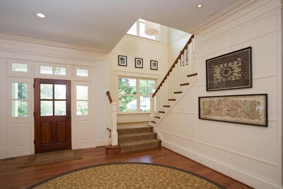 Design ideas for a traditional entryway in DC Metro with white walls and a single front door.