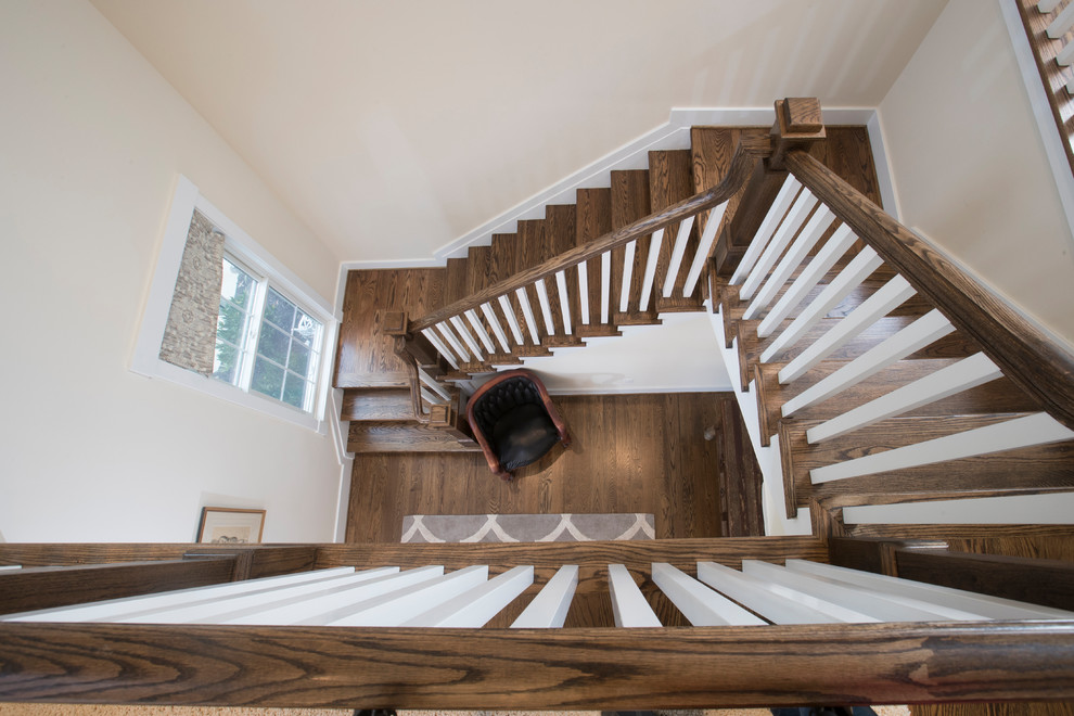 Design ideas for a large transitional wood u-shaped staircase in Baltimore with wood risers and wood railing.