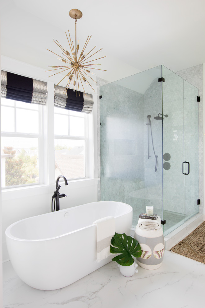Aménagement d'une salle de bain bord de mer avec une baignoire indépendante, une douche d'angle, un carrelage gris, mosaïque, un mur blanc, un sol blanc, une cabine de douche à porte battante et une niche.