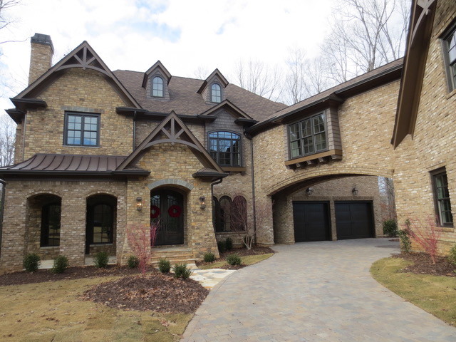 Inspiration for a large transitional two-storey brown exterior in Atlanta with mixed siding and a gable roof.