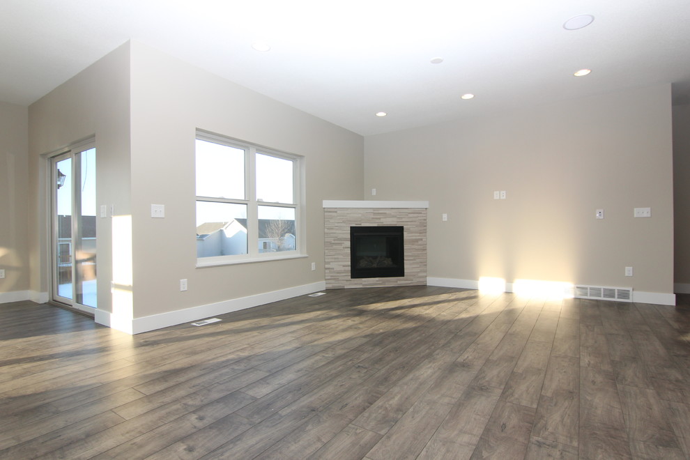 Photo of a large modern open concept living room in Cedar Rapids with a corner fireplace and a tile fireplace surround.
