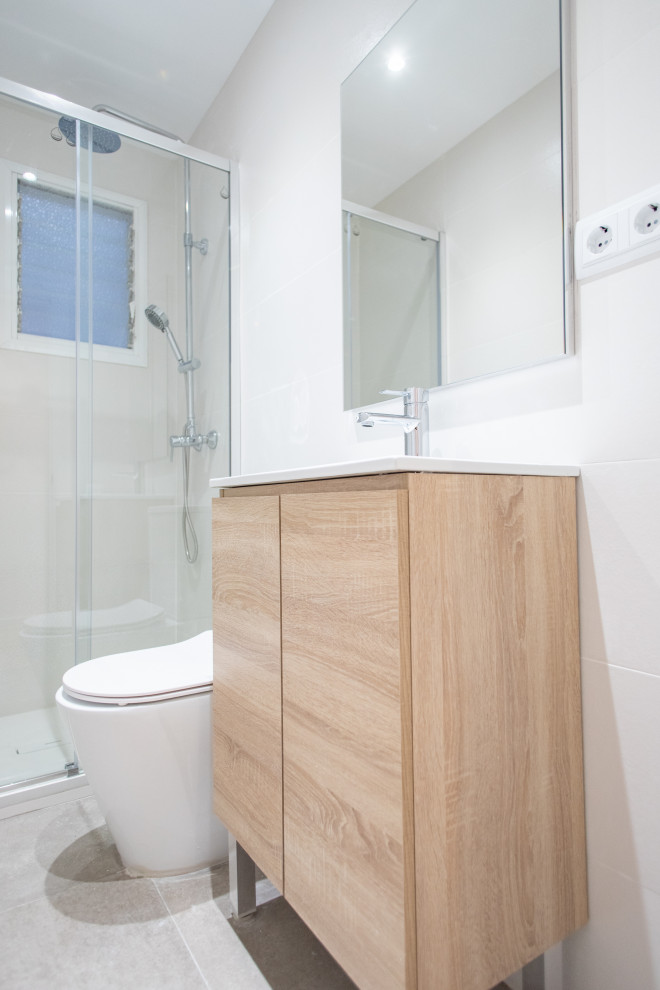 Inspiration for a medium sized mediterranean ensuite bathroom in Barcelona with flat-panel cabinets, medium wood cabinets, a built-in shower, a one-piece toilet, beige tiles, ceramic tiles, ceramic flooring, a trough sink, beige floors, a sliding door, white worktops, an enclosed toilet, a single sink and a built in vanity unit.